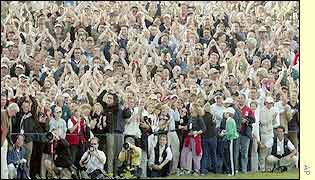 The crowd are delighted as Paul McGinley successfully makes the winning putt at The Belfry