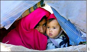Afghan refugee mother and child in tent 