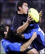 Daryl Gibson is tackled while playing for New Zealand against Italy