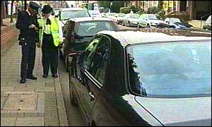 Council attendant and traffic warden confer