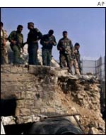Palestinian policemen stand guard on the biblical Tomb of Joseph 