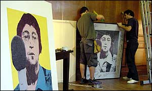 Workmen preparing to put John Lennon pictures on the walls of the Fame Academy house, Witanhurst House
