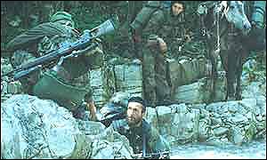Chechen rebels cross stream, pictured by Roddy Scott