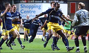 Oxford United's winning penalty scorer Jefferson Louis celebrates with goalkeeper Andy Woodman 