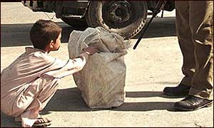A child being put through a security check in Kashmir 