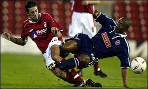 Nottingham Forest's John Thompson (left) and Fitzroy Simpsonof Walsall go in for a crunching tackle