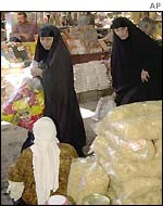 Iraqi women shop in a market in Baghdad