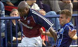 Ipswich's Finidi George takes on Sartid's Milorad Zecevic