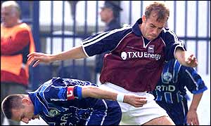 Jamie Clapham gets the better of Sartid captain Goran Bogdanovic