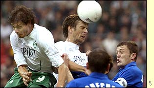 Werder Bremen's Bosnian Mladen Krstajic heads the ball, before Greek Angelos Caristeas, and Ukrainian Volodymyr Yaksmanytskyy and Vyacheslav Checher