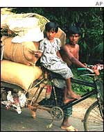 Family transporting belongings by tricycle in Bangladesh
