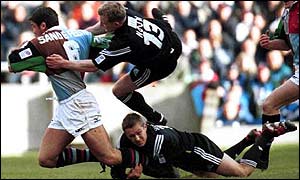 Pat Sanderson of Quins is stopped by Jamie Noon and Jonny Wilkinson last year