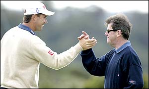 Padraig Harrington and JP McManus celebrate a successful putt from the Irishman as he continues to lead the tournament