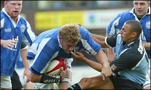 Bridgend lock Andy Moore is tackled by Cardiff's Anthony Sullivan