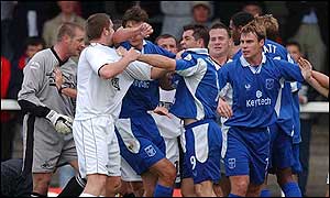 Swansea's Andrew Mumford and Michael Oliver of Rochdale lock horns