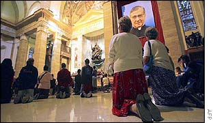 Pilgrims pray in front of the remains of Opus Dei founder Jose Maria Escriva de Balaguer in Rome