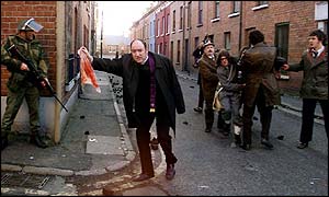 Brian Devlin portraying Father Edward Daly 