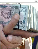Someone holding a large amount of Afghan currency