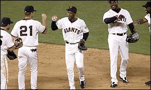 Kenny Lofton shares a high five with Giants' team-mate Jeff Kent after their victory over the Atlanta Braves 