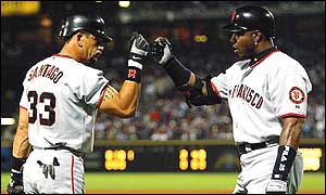 Bonds (right) and Santiago celebrate during the game-five decider against the Braves