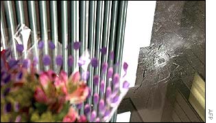Flowers and bullet hole after one of the Maryland shootings