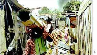 Immigrants leaving their burnt out shacks 