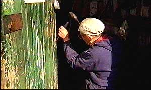 Volunteer repairs door