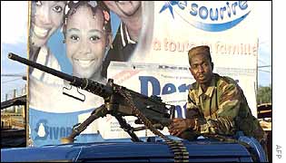 Rebel soldier with machine gun on pick-up truck