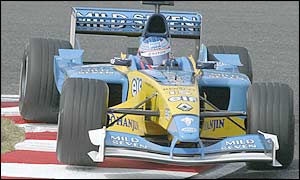 Jenson Button races the Renault