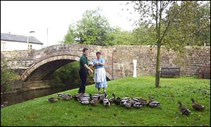 Store owner Phil Woodhead and employee Jean Sutcliffe feed the ducks at Dunsop Bridge