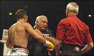 Darkie Smith is restrained by his son after pushing Micky Vann