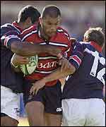 Robert Todd is shackled by Jim Williams and Rob Henderson of Munster