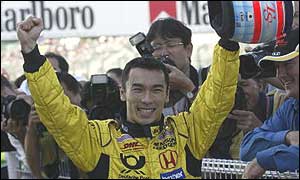 Takuma Sato celebrates his seventh place on the grid