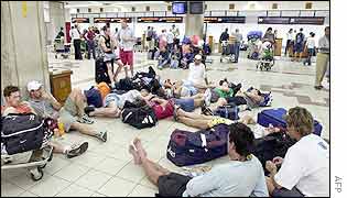 Foreign tourists wait in the airport, trying to leave Bali