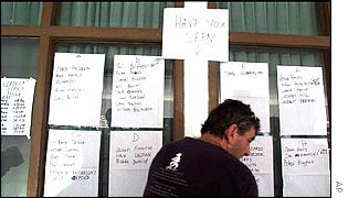 Man looks at lists of missing at a Bali hospital