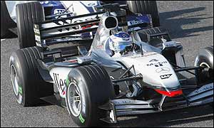 McLaren driver Kimi Raikkonen finishes in third, just ahead of Juan Pablo Montoya