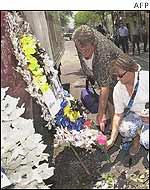 Tourists lay bouquets of flowers at the blast site in Bali
