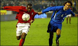 England striker Emile Heskey fights for the ball