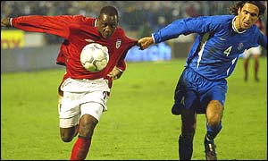 Emile Heskey (left) is held back by Slovakia's Peter Hlinka