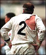 Brian Moore's shirt is ripped as he plays for England