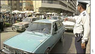 A policeman directs traffic in Baghdad