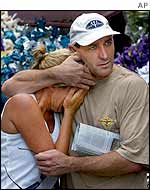 Stuart Cram comforts his sister Tia Byron from Sydney, Australia, who is the mother of a 14-year-old victim Chloe Byron
