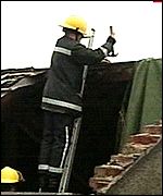 Fireman fixes a roof