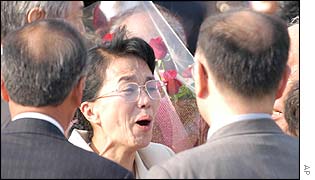 Fukie Hamamoto (centre) is greeted by family members