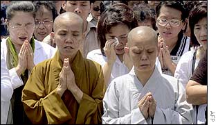 Buddhists and others pray during a memorial services in Denpasar, the capital city of Bali, 15 October 2002