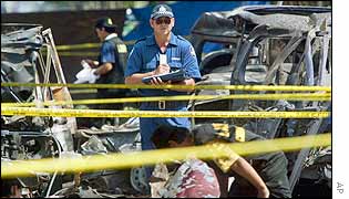 An officer of Australian Forensic team investigates the site of the deadly nightclub bombing in Kuta, Bali, Indonesia, 16 Oct 2002. 
