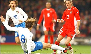 Italy's Massimo Ambrosini tackles Robbie Savage 