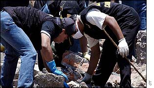 Police search the site of the blast in Kuta 