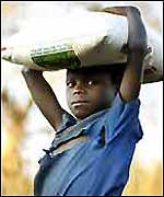 Malawian orphan with flour sack (photo: Tearfund)