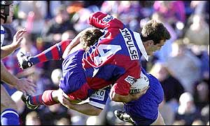 Julian Bailey (number four) is taken out by the Bulldogs defence